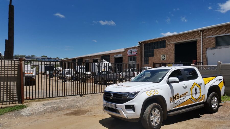 NS Security branded vehicle guarding an industrial site entrance
